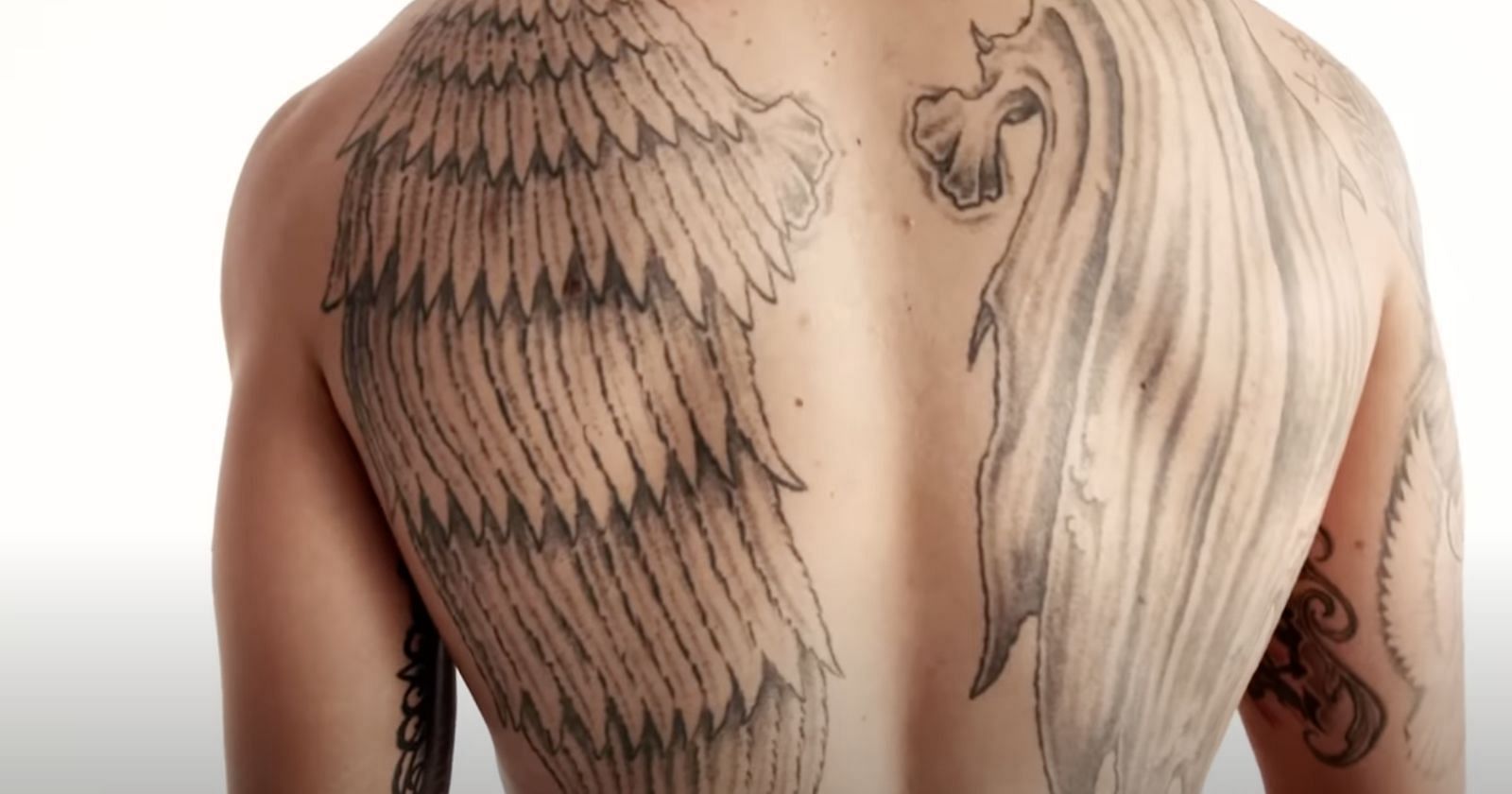 Max Holloways Back Tattoo: Angel and Demon Wings Symbolizing Balance